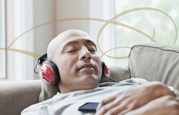 Man relaxing on a couch with headphones